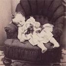 Bare-footed child on armchair
